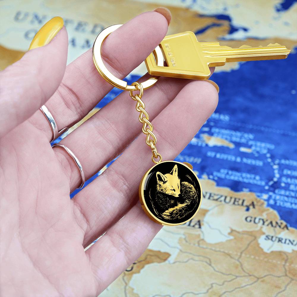 Woman holding an Elegant Gold pendant featuring a Personalized Fox Keychain, With a gold Fox Set against a black background. This jewelry offers Customization with an engraving option for a name.