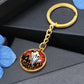 An elegant gold pendant Halloween Ghost Keychain. The colors are white, black, yellow, orange and green. This jewelry offers personalization with an engraving option for a name.