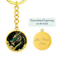 an Elegant gold pendant featuring a vivid Jade Dragon keychain set against a gold and black backdrop. This jewelry offers personalization with an engraving option for a name.