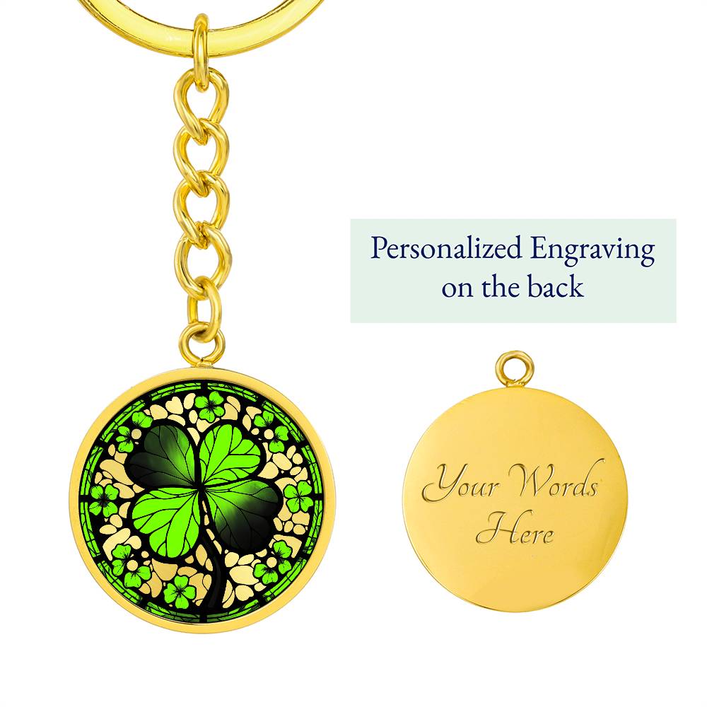 Elegant Gold pendant featuring a vivid Four Leaf Clover Keychain, set against a gold backdrop. This jewelry offers personalization with an engraving option for a name